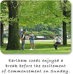 Three college girls under large shade tree.  "Earlham coeds enjoyed a break before the excitement of Commencemnt on Sunday."
