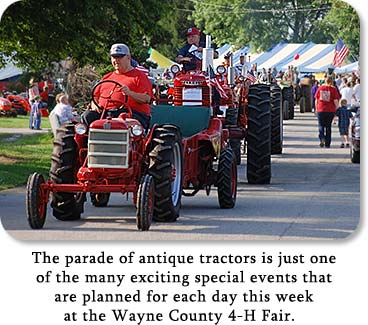 Photo: Tractor Parade.  Text: The parade of antique tractors is just one of the many exciting special events that are planned for each day this week at the Wayne County 4-H Fair.