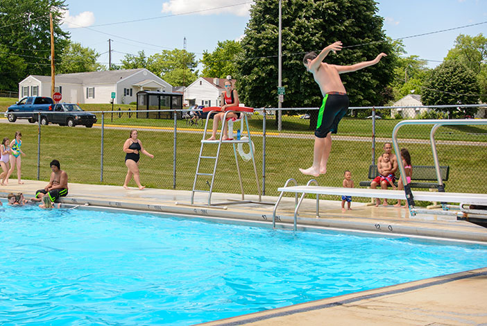 Photo: Boy jumps on diving board at Municipal Pool.