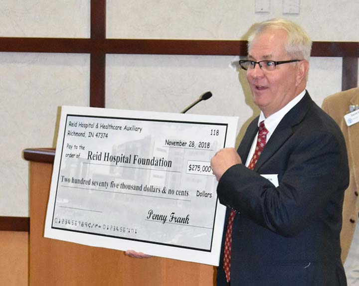 Supplied Photo: Randy Kirk, Reid Health Vice President/Foundation President, displays the symbolic "check" for the annual Auxiliary donation.
