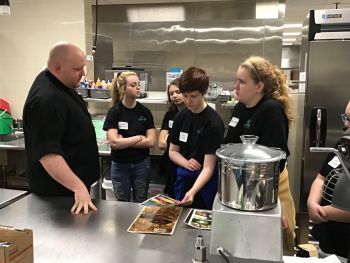 Supplied Photo: Reid Health Chef Dugan Wetzel shares about food and catering services with Northeastern students.