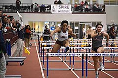 Supplied Photo: Woman jumps hurdles on indoor track.