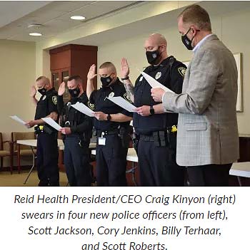 Supplied Photo:  Reid Health President/CEO Craig Kinyon (right) swears in four new police officers (from left) Scott Jackson, Cory Jenkins, Billy Terhaar, and Scott Roberts.