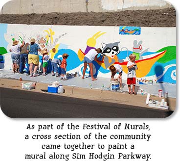As part of the Festival of Murals, a cross section of the community came together to paint a mural along Sim Hodgin Parkway.